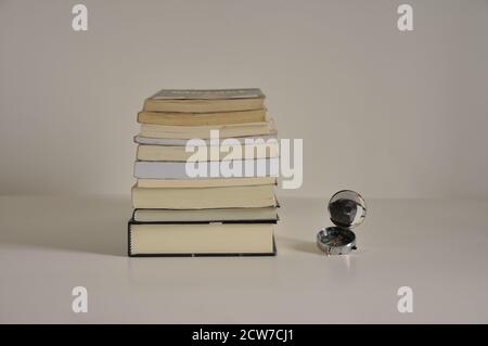 Stack of books, books on various themes, conceptual photo, with compass on the side, side view, white background, Brazil, South America, copy space Stock Photo