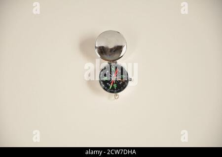 Compass, with aluminum case used for adventure tours, exploration or orienteering race, view from above, white base, Brazil, South America Stock Photo