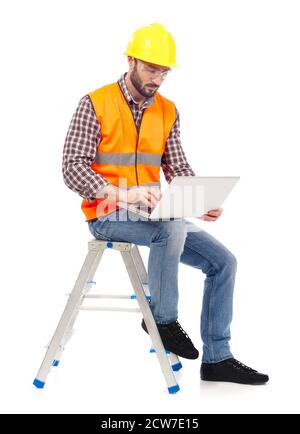 Building contractor working on laptop Stock Photo