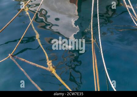 Boat Ropes creating  abstract textures on the surface of the water. Stock Image. Stock Photo