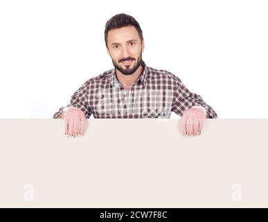 Cheerful handyman holding a blank board, white background Stock Photo