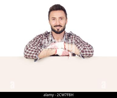Cheerful handyman with blank board, white background Stock Photo