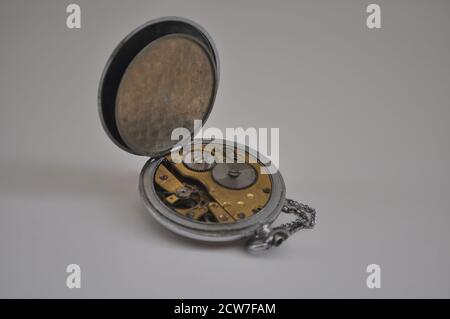 Pocket watch. Vintage pocket watch mechanism, with open back showing all machinery, white background, Brazil, South America Stock Photo