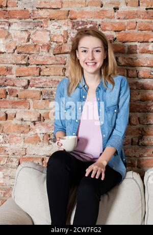Smiling woman having a coffee Stock Photo