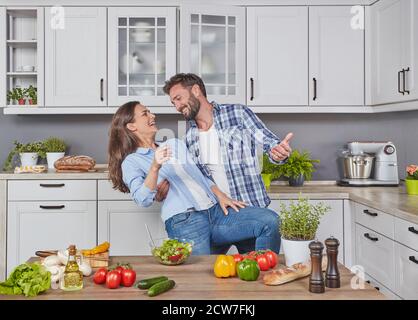 Happy couple dancing in the kitchen Stock Photo