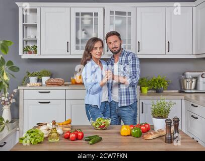 Happy couple dancing in the kitchen Stock Photo