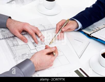 People working on blueprints Stock Photo