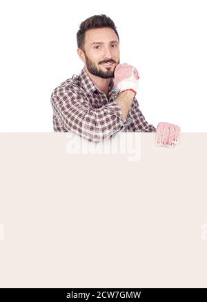 Cheerful handyman with blank board, white background Stock Photo