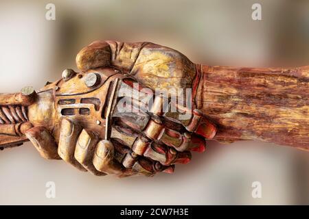 Shaking hands sculpture with a Grunge look create an industrial steampunk. Machine parts, and mechanical machinery make for a nice grunge look Stock Photo