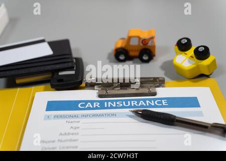 While taking a picture of the concept of car accident, I thought of car insurance, so I added insurance documents and props. Stock Photo