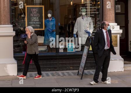 London, UK.  28 September 2020.  People outside the exterior of a private Covid-19 test centre on Fleet Street, with a sign in the window advertising same day results.  It is reported that some Covid-19 test results are taking too long to be processed at community test centres.  Credit: Stephen Chung / Alamy Live News Stock Photo