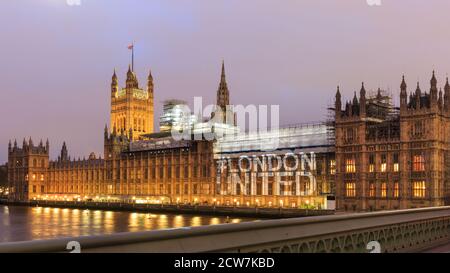 The 'London United' social media hashtag is projected onto the Hourses of Parliament on the anniversary of the Westminster terrorist attacks, London, Stock Photo