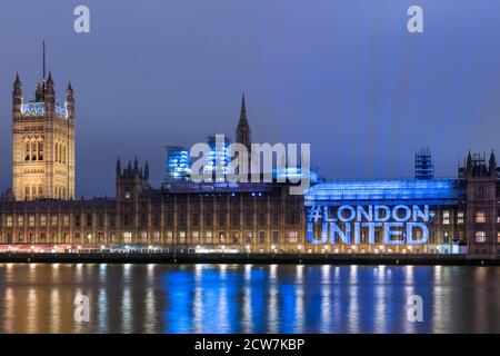 The 'London United' social media hashtag is projected onto the Hourses of Parliament on the anniversary of the Westminster terrorist attacks, London, Stock Photo