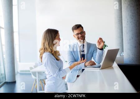 Creative young people working on a laptop at startup office Stock Photo