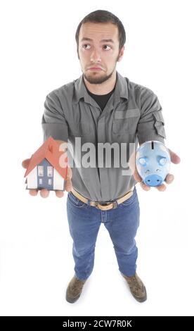 Man with piggy bank and model house Stock Photo