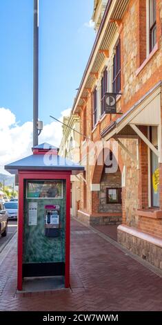 Telstra public red telephone booth in front of York Post Office stone and brick building on Avon Terrace York Western Australia. Stock Photo