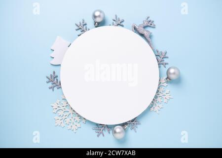 Christmas composition with silver gifts. White paper blank circle shape on blue background. Christmas template. Flat lay, top view, copy space - Image Stock Photo