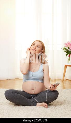 Pregnant woman listening to music Stock Photo