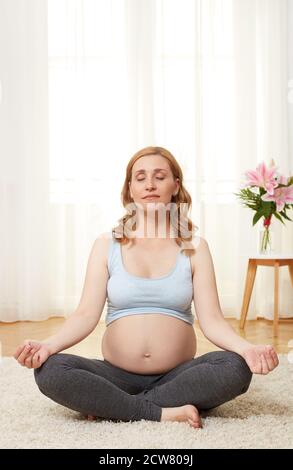 Young pregnant woman meditating Stock Photo