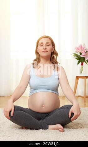 Young pregnant woman meditating Stock Photo