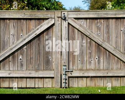 Close crop of a large wooden gate in a garden with latches Stock Photo