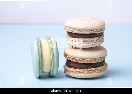 Close up of delicious french macarons. Different types of macaroons on a blue background - Image Stock Photo
