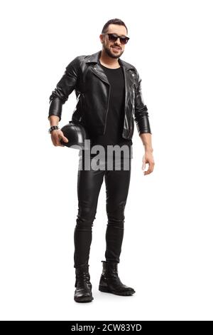 Full length portrait of a biker in leather jacket and pants holding a leather helmet isolated on white background Stock Photo