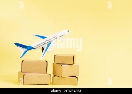 Airplane and stack of cardboard boxes. concept of air cargo and parcels, airmail. Fast delivery of goods and products. Cargo aircraft. Logistics Stock Photo