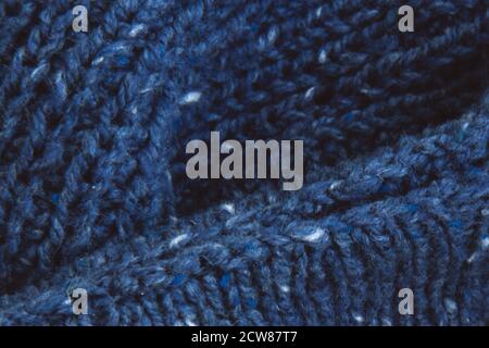 Texture beautiful knitted blue fabric as background. Copy space. Female hobby concept. Knitting Stock Photo