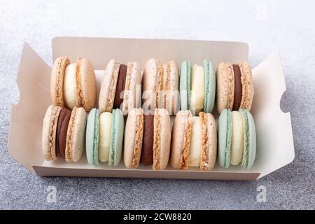Box with various delicious french macarons. Set of different macaroons - chocolate, blue cheese and vanilla cream - Image Stock Photo