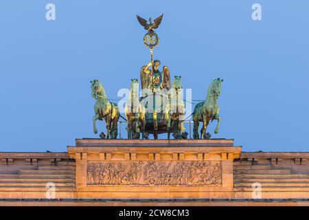 Sunrise at the the Brandenburg Gate (German: Brandenburger Tor), an 18th-century neoclassical monument in Berlin, Germany. Atop the gate is a Quadriga Stock Photo