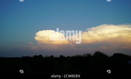 Dense clouds in twilight sky in winter evening.Image of cloud sky on evening time.Evening Vivid sky with clouds. Stock Photo