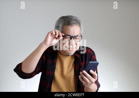The Asian man standing on the white background. Stock Photo