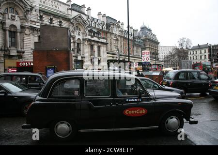 London, UK - February 26, 2011: Taxi in the street of London. Black cabs are the most iconic symbol of London as well as London's Red Double Decker Bu Stock Photo