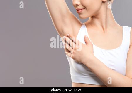 Unrecognizable woman touching her armpit, copy space Stock Photo