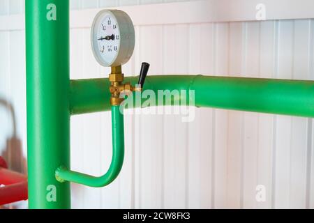 Pressure sensors on the pipeline painted in green hot water show the pressure. Stock Photo