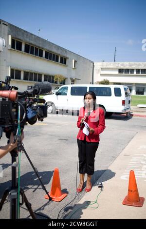 Austin, TX August 31, 2008: Hispanic TV news reporter goes live during a visit of President Bush to Austin, Texas. ©Bob Daemmrich Stock Photo