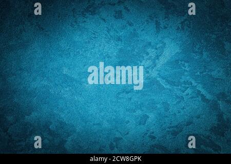 Cyan decorative plaster texture with vignette. Abstract grunge background with copy space for design. Stock Photo