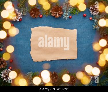 Christmas and Happy New Year dark blue background with craft paper for text and bokeh Stock Photo