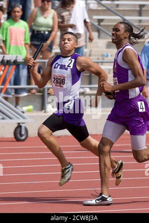 Austin, TX May 10, 2008: Hispanic and African-American boys compete in the 1600-meter relay at the Texas state high school track meet at the University of Texas at Austin. ©Bob Daemmrich Stock Photo