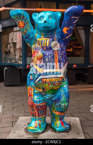 Colorful fiberglass Buddy Bear statue, the symbol of Berlin raising his hands Stock Photo