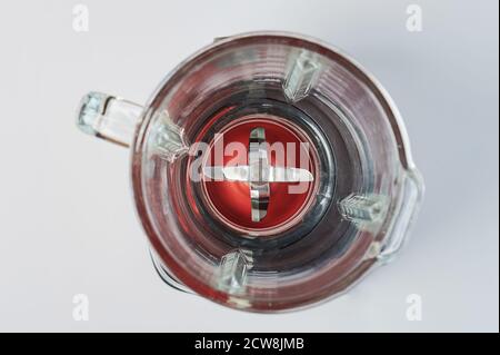 Glass cup with blades of mixer above top view isolated Stock Photo