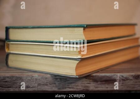 three old books in a library. Knowledge education concept Stock Photo