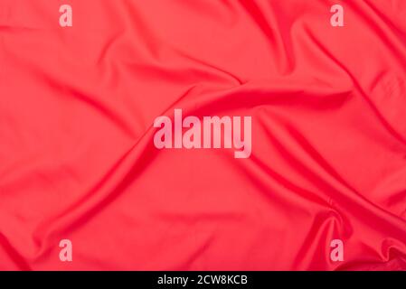 Natural red fabric, texture of red wavy cloth, top view Stock Photo