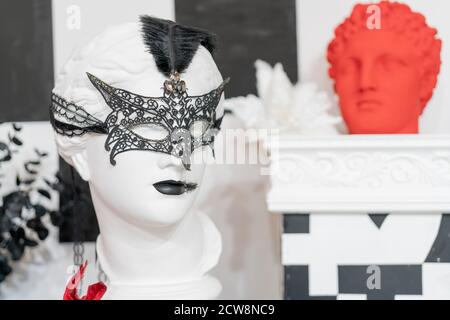 Plaster head in a carnival mask. Decorative decorations in a shop window. Stock Photo