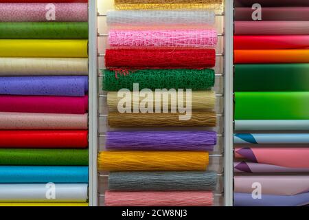 Multicolored rolls of wrapping paper on the showcase. Abstract background. Stock Photo