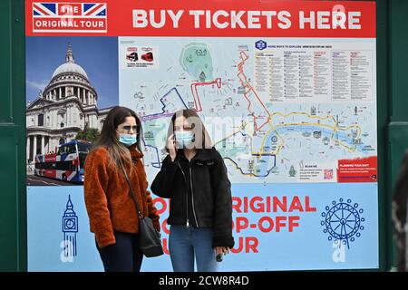 Tourists wearing face masks in Trafalgar Square, London, UK, during the coronavirus pandemic. September 27, 2020. Stock Photo