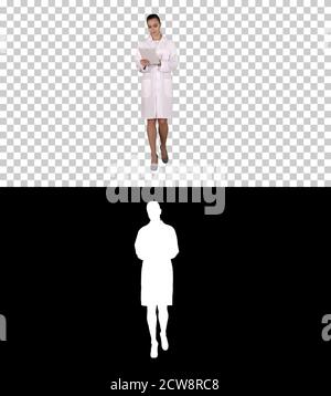Doctor using tablet while walking, Alpha Channel Stock Photo