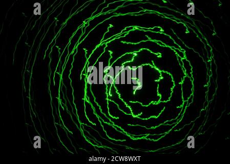 Abstract lines of green laser light on black background Stock Photo