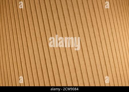 Orange and lit fabric surface. Tilted and striped pattern. Abstract high resolution full frame textured background. Shallow depth of field. Stock Photo